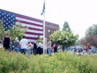 Group Standing in Front of the Displayed American Flag on Memorial Day