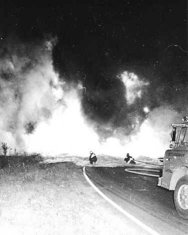 Firefighters Trudging Through Snow to Attend to a Fire